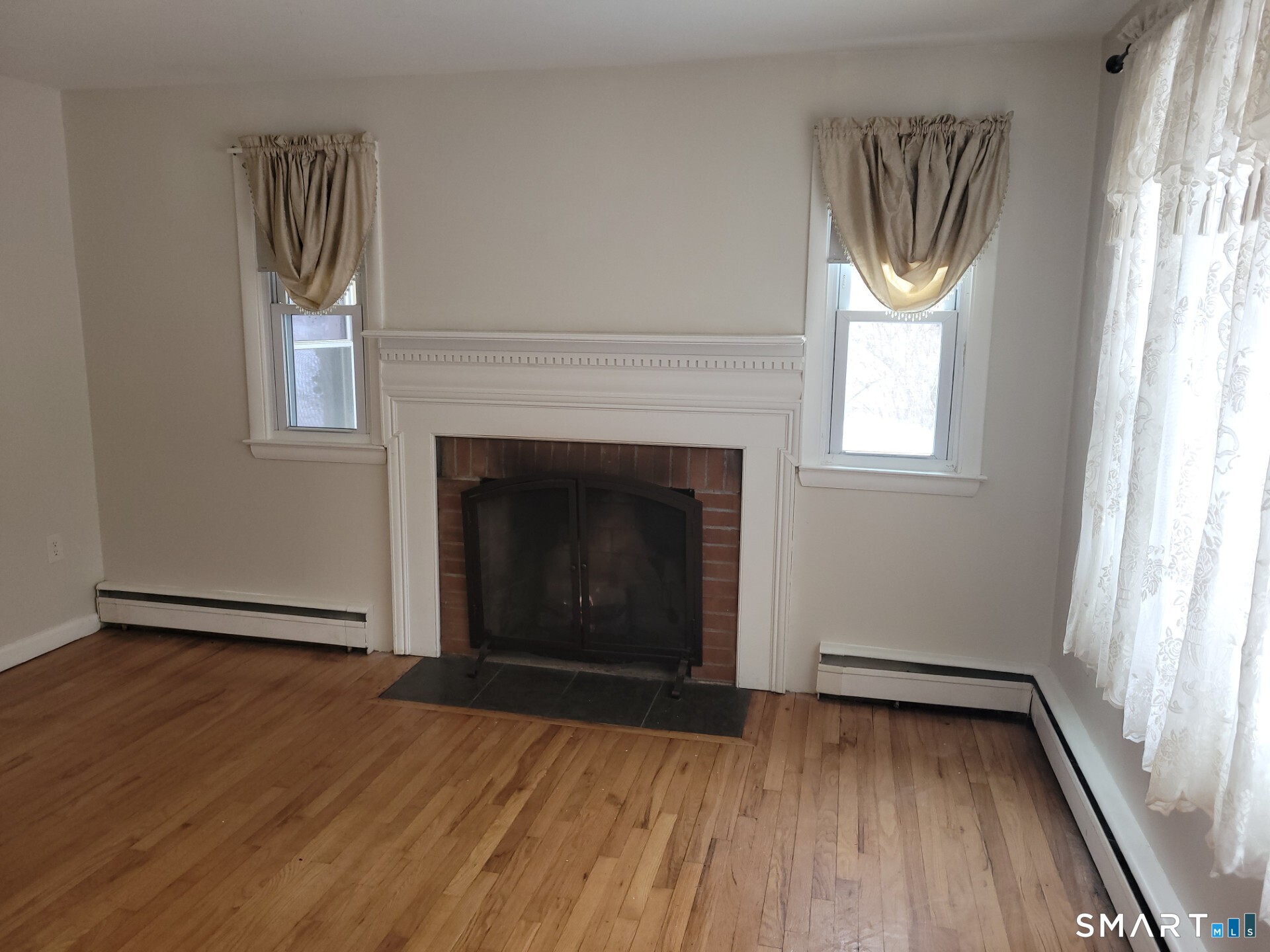 41 East Granby Road Granby, CT 06035 - Photo 6 of 61 a view of an empty room with wooden floor and a window