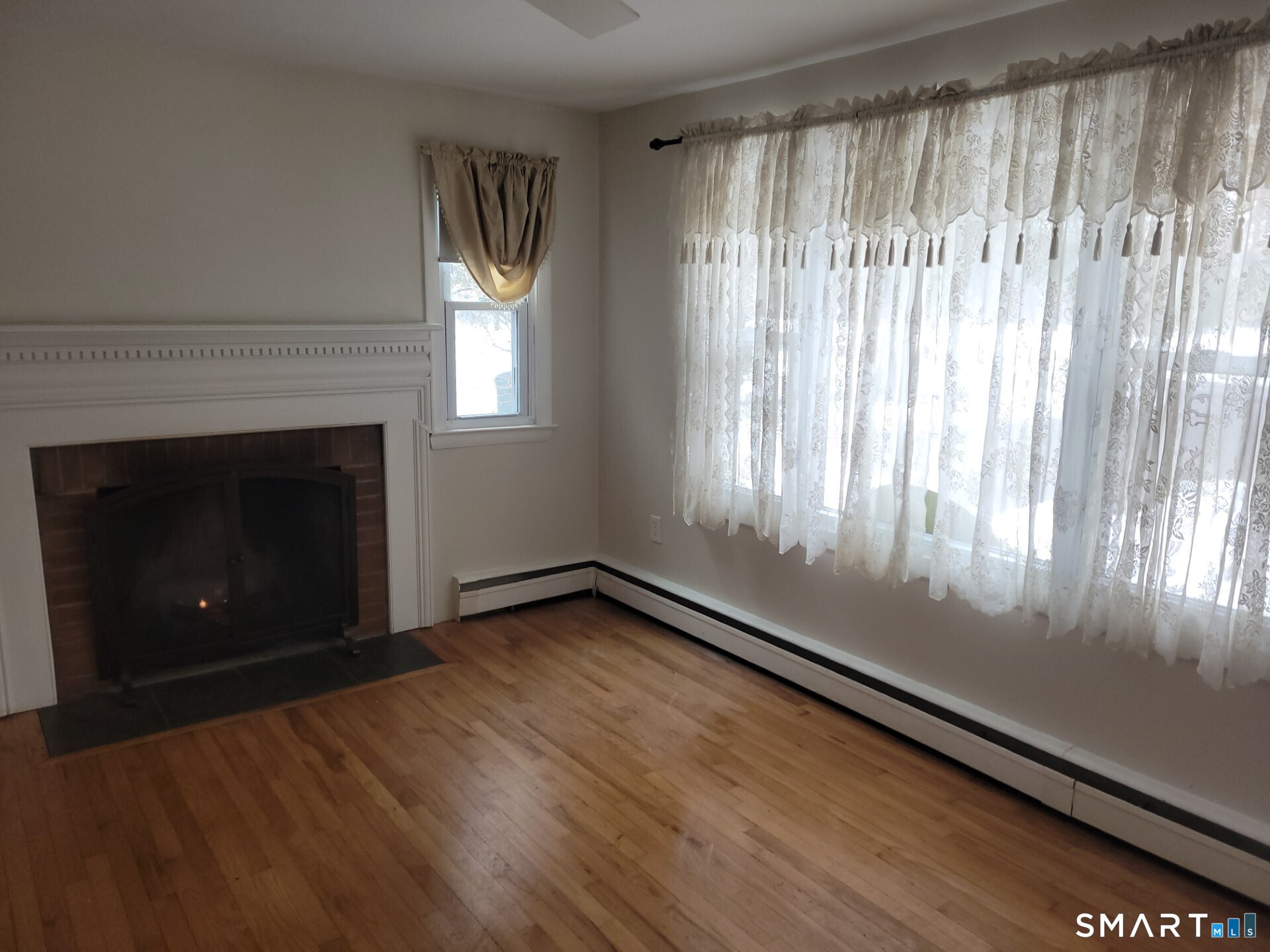 41 East Granby Road Granby, CT 06035 - Photo 7 of 61 a view of an empty room with wooden floor and a window