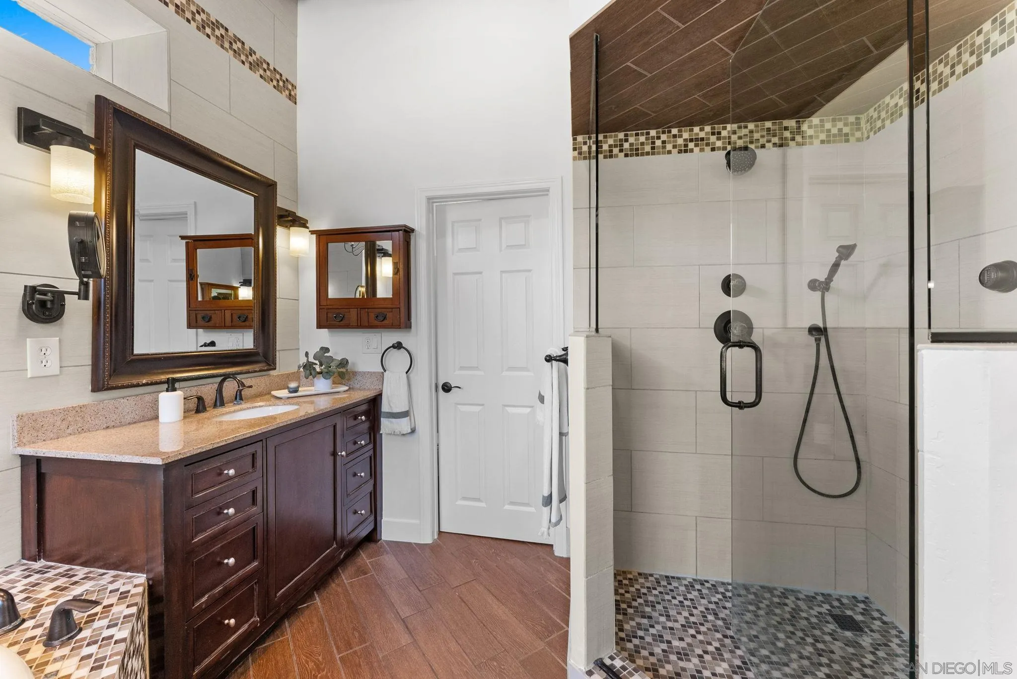 12832 Stone Canyon Road Poway, CA 92064 - Photo 21 of 60 a bathroom with a double vanity sink a toilet and shower