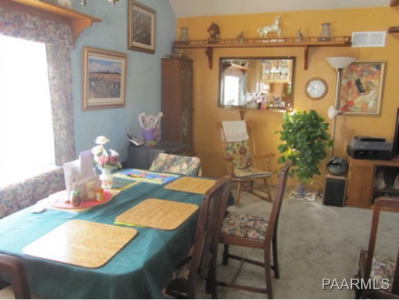 2620 North Reed Road Chino Valley, AZ 86323 - Photo 6 of 23 a view of a dining room with furniture window and wooden floor