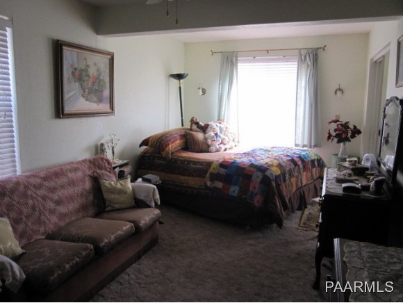 2620 North Reed Road Chino Valley, AZ 86323 - Photo 8 of 23 a bedroom with bed couch and window