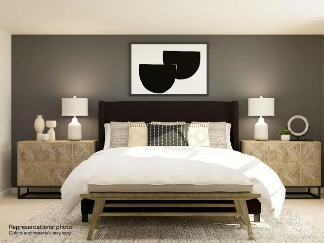 a bedroom with a bed and lamp