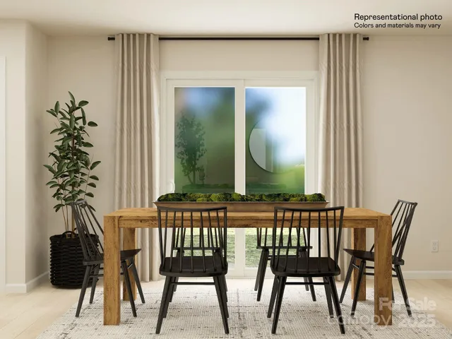 a view of a dining room with furniture and a potted plant