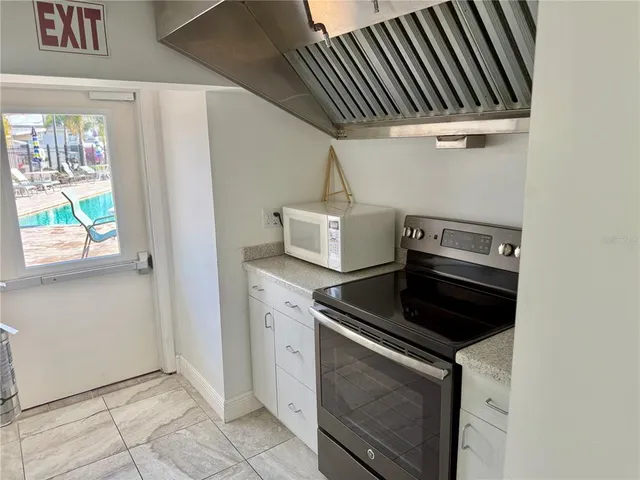a living room with lots of furniture and kitchen view