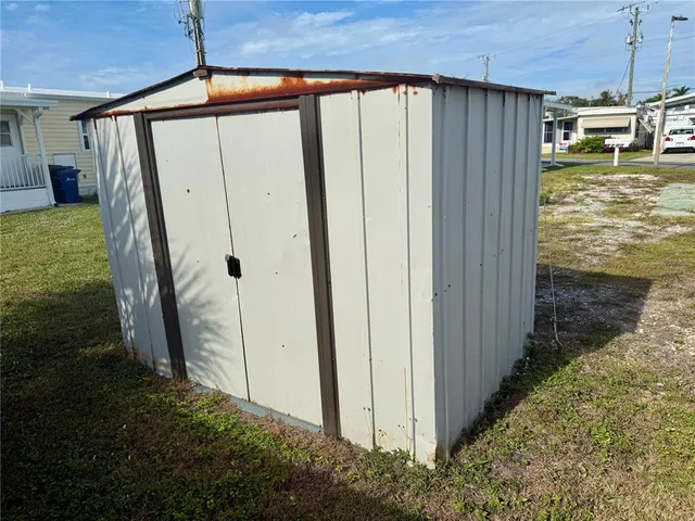 a room with lots of wooden furniture a dining table and chairs
