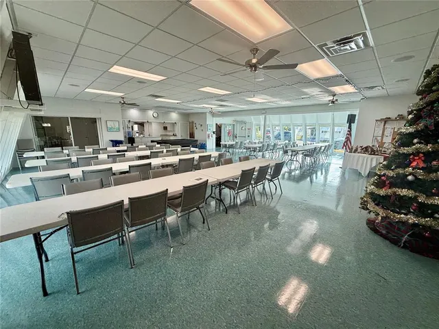 a large kitchen with a table and chairs