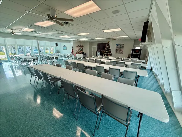 a view of a dining room with furniture and a book shelf