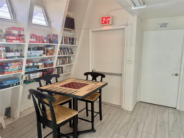 a kitchen with a sink dishwasher and a clock on the wall
