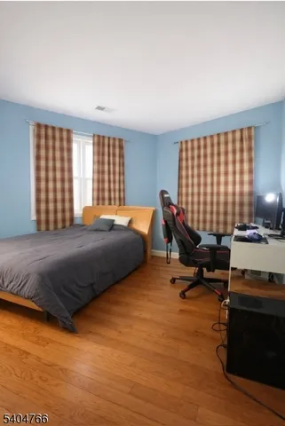 a bedroom with a bed and a night stand