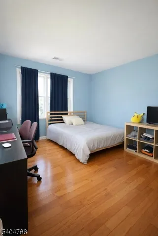 a bedroom with a bed and a chair in it