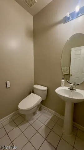 a bathroom with a sink mirror and toilet