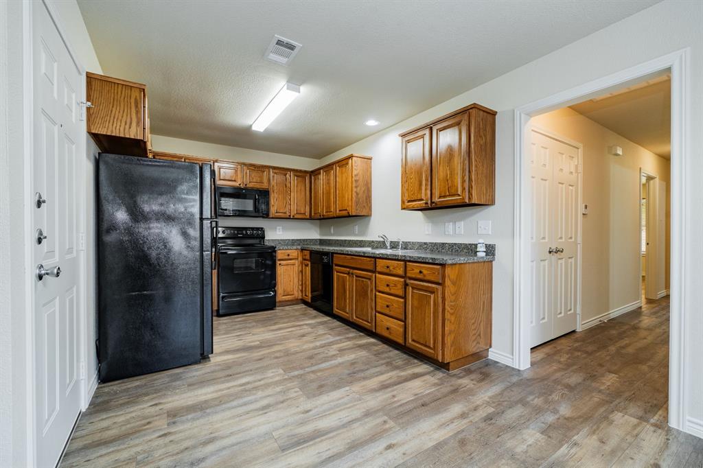 26 Duplex Portfolio Commerce, TX 75428 - Photo 17 of 39 a kitchen with stainless steel appliances granite countertop a refrigerator and a stove top oven