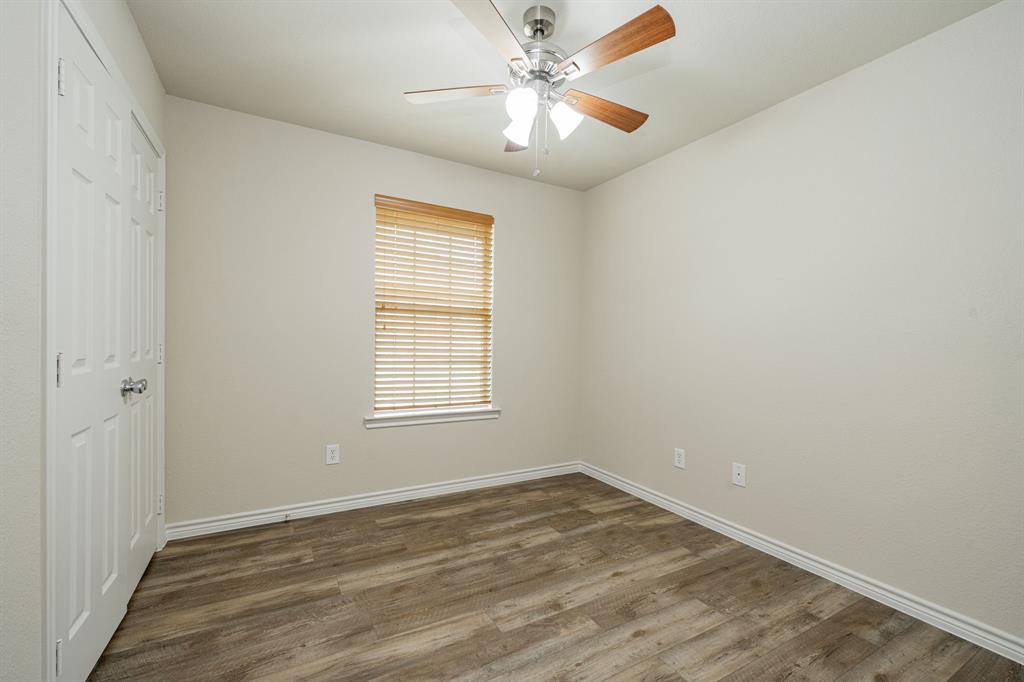 26 Duplex Portfolio Commerce, TX 75428 - Photo 21 of 39 an empty room with a window and a fan