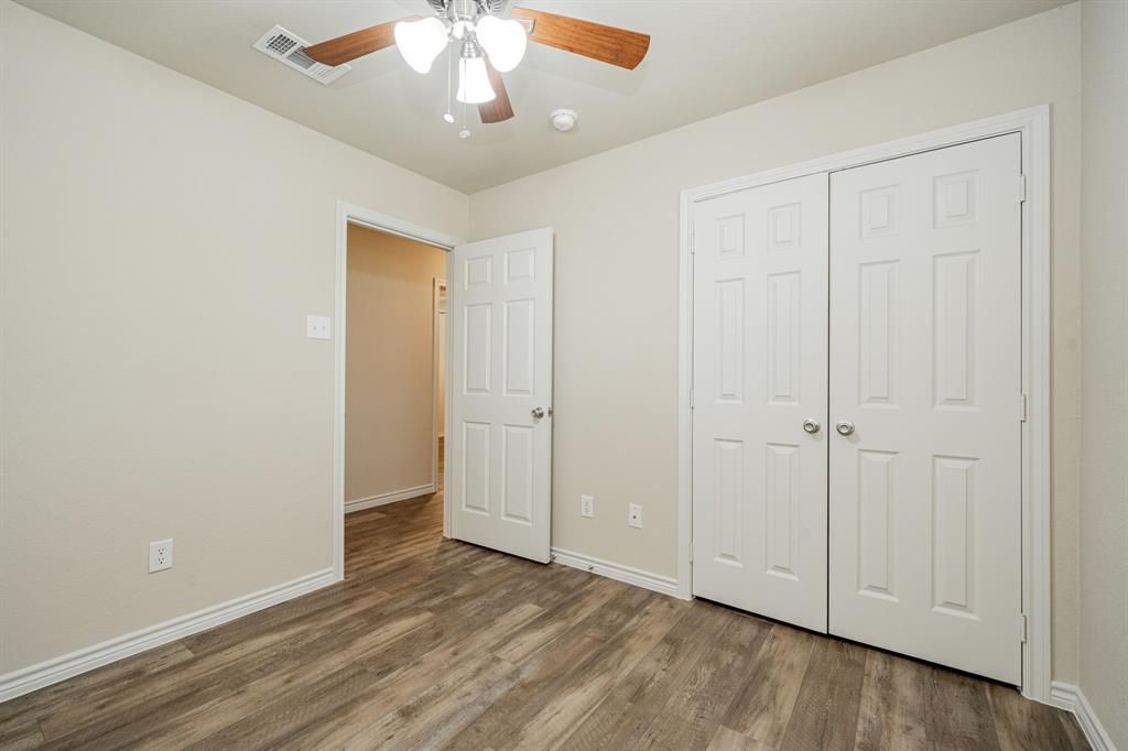 26 Duplex Portfolio Commerce, TX 75428 - Photo 22 of 39 a view of an empty room with wooden floor