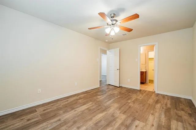 an empty room with closet and fan