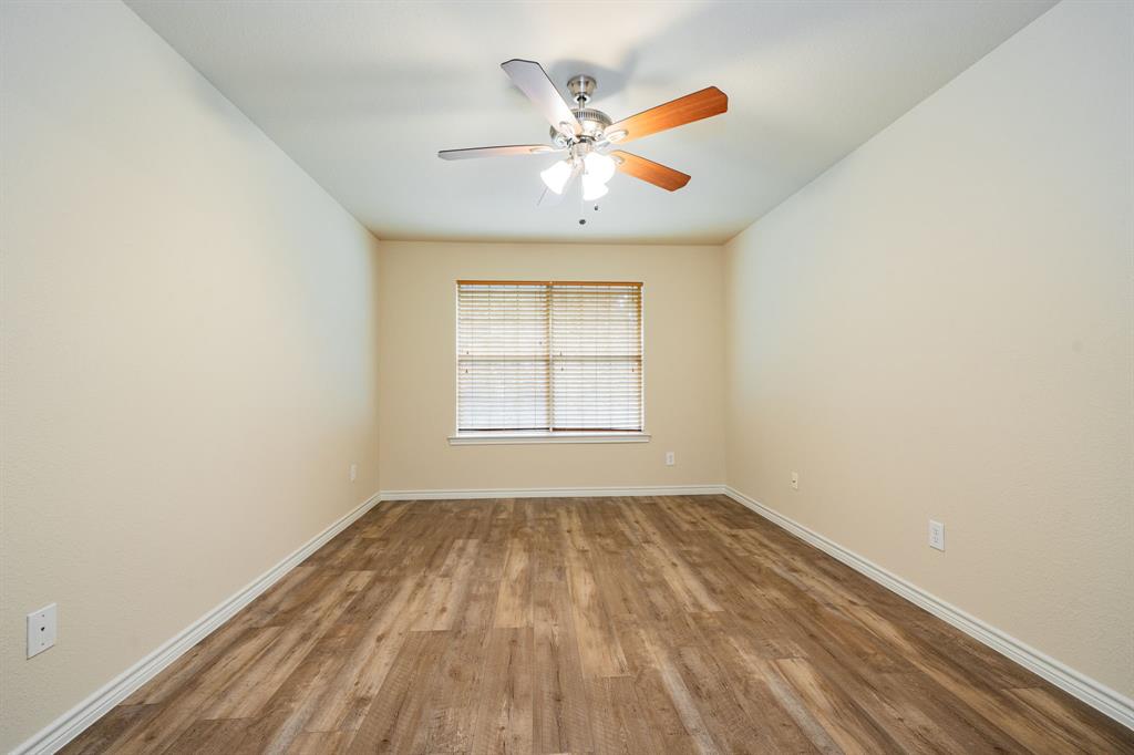 26 Duplex Portfolio Commerce, TX 75428 - Photo 25 of 39 an empty room with a window and a ceiling fan