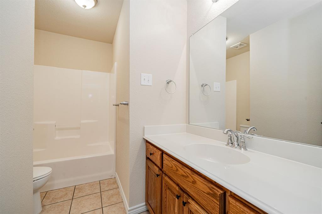 26 Duplex Portfolio Commerce, TX 75428 - Photo 28 of 39 a bathroom with a sink a toilet and shower