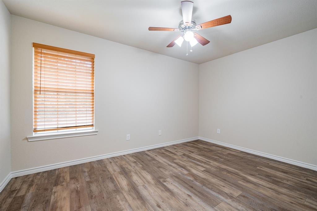 26 Duplex Portfolio Commerce, TX 75428 - Photo 29 of 39 wooden floor in an empty room with a window