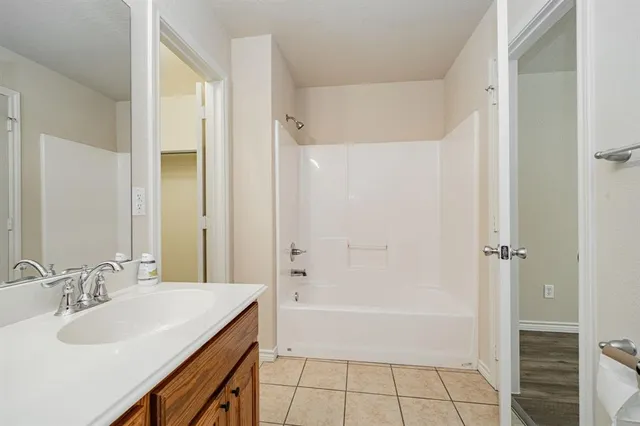 a bathroom with a sink a mirror and a bathtub