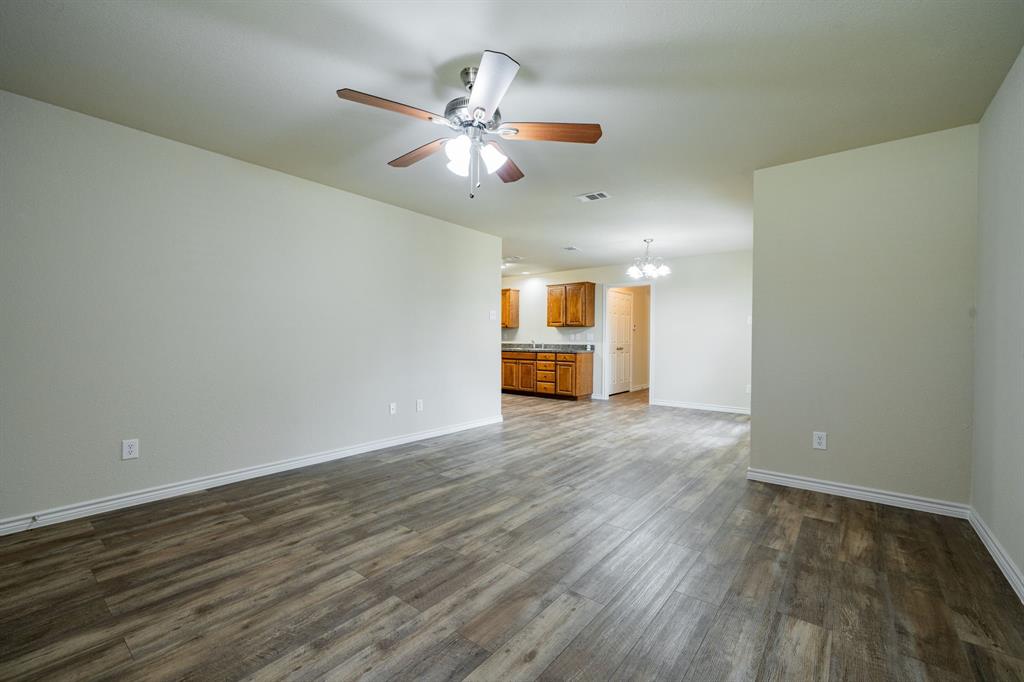 26 Duplex Portfolio Commerce, TX 75428 - Photo 35 of 39 a view of empty room with wooden floor and fan