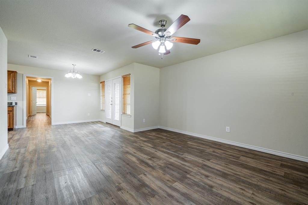26 Duplex Portfolio Commerce, TX 75428 - Photo 36 of 39 an empty room with wooden floor and windows