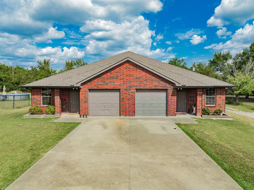 26 Duplex Portfolio Commerce, TX 75428 - Photo 5 of 39 a front view of a house with a yard and garage