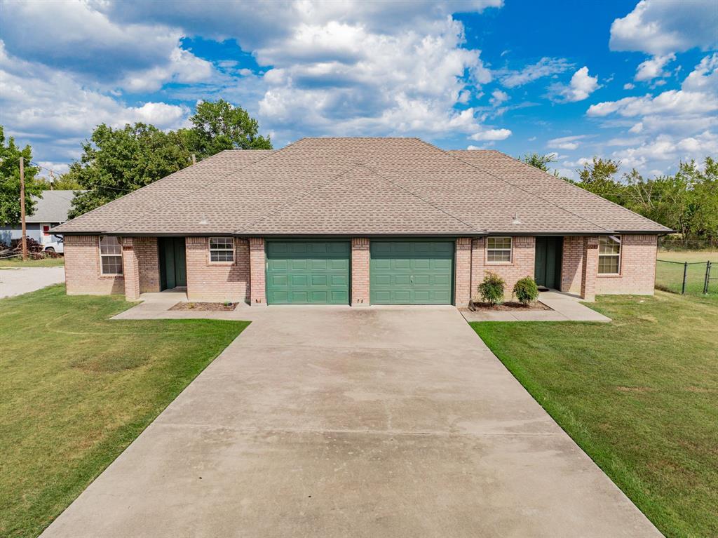26 Duplex Portfolio Commerce, TX 75428 - Photo 6 of 39 a front view of a house with a garden