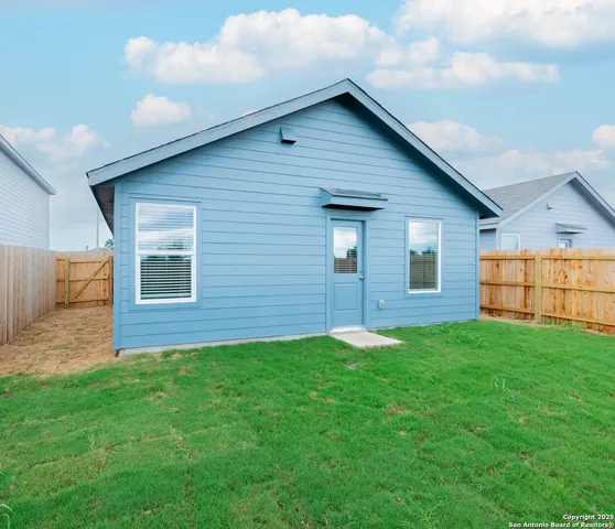 a view of front of house with a yard