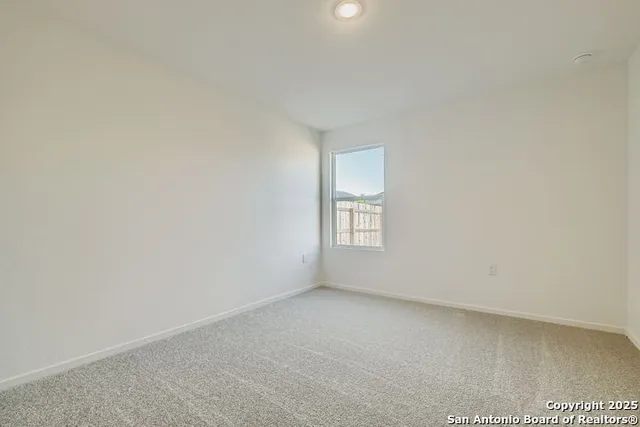 a view of an empty room and a window