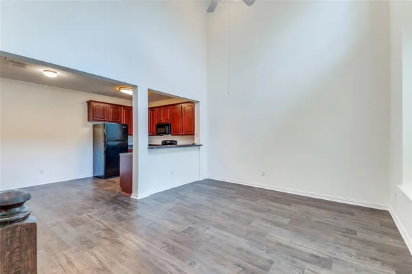 a view of kitchen with refrigerator and window