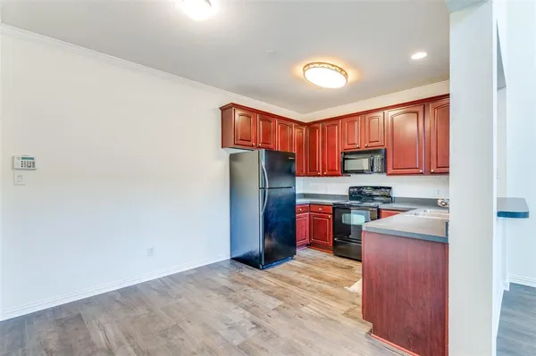 a kitchen with refrigerator and window