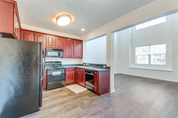 a kitchen with stainless steel appliances granite countertop a refrigerator and a stove