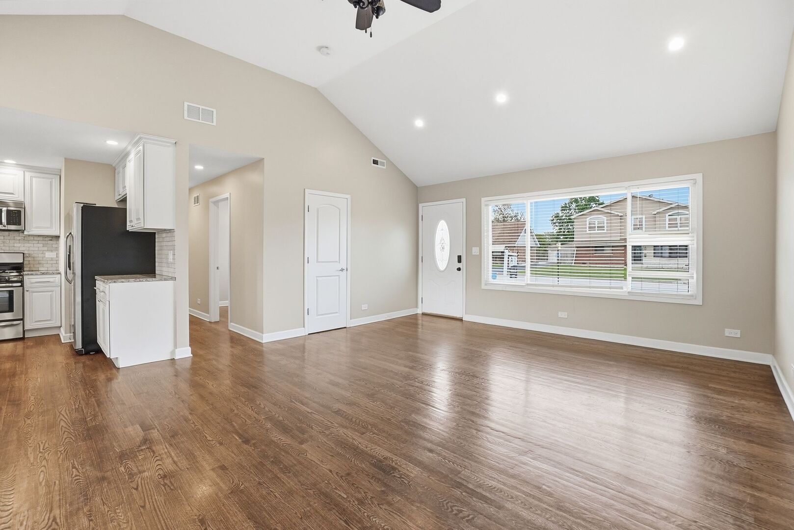 8718 Cranbrook Lane Bridgeview, IL 60455 - Photo 3 of 24 a view of a kitchen with wooden floor and a window