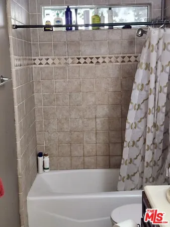 a bathroom with a bathtub and shower