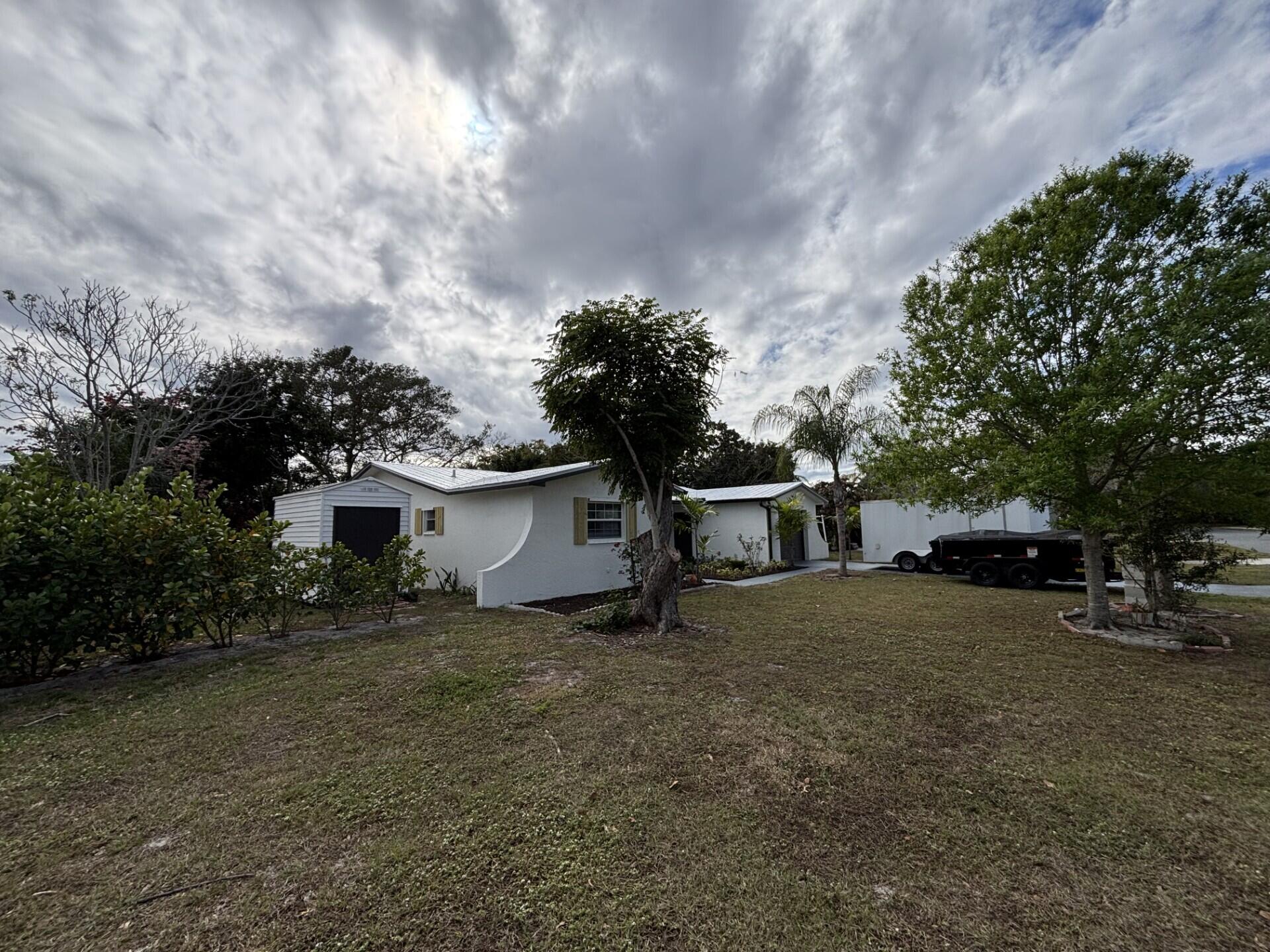 1160 East 12th Street Stuart, FL 34996 - Photo 1 of 25 a front view of a house with a yard