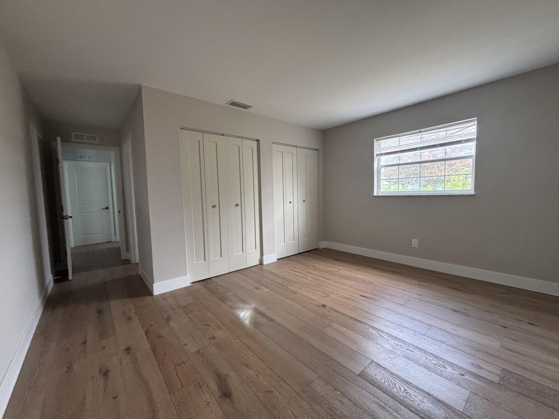1160 East 12th Street Stuart, FL 34996 - Photo 16 of 25 a view of an empty room with wooden floor