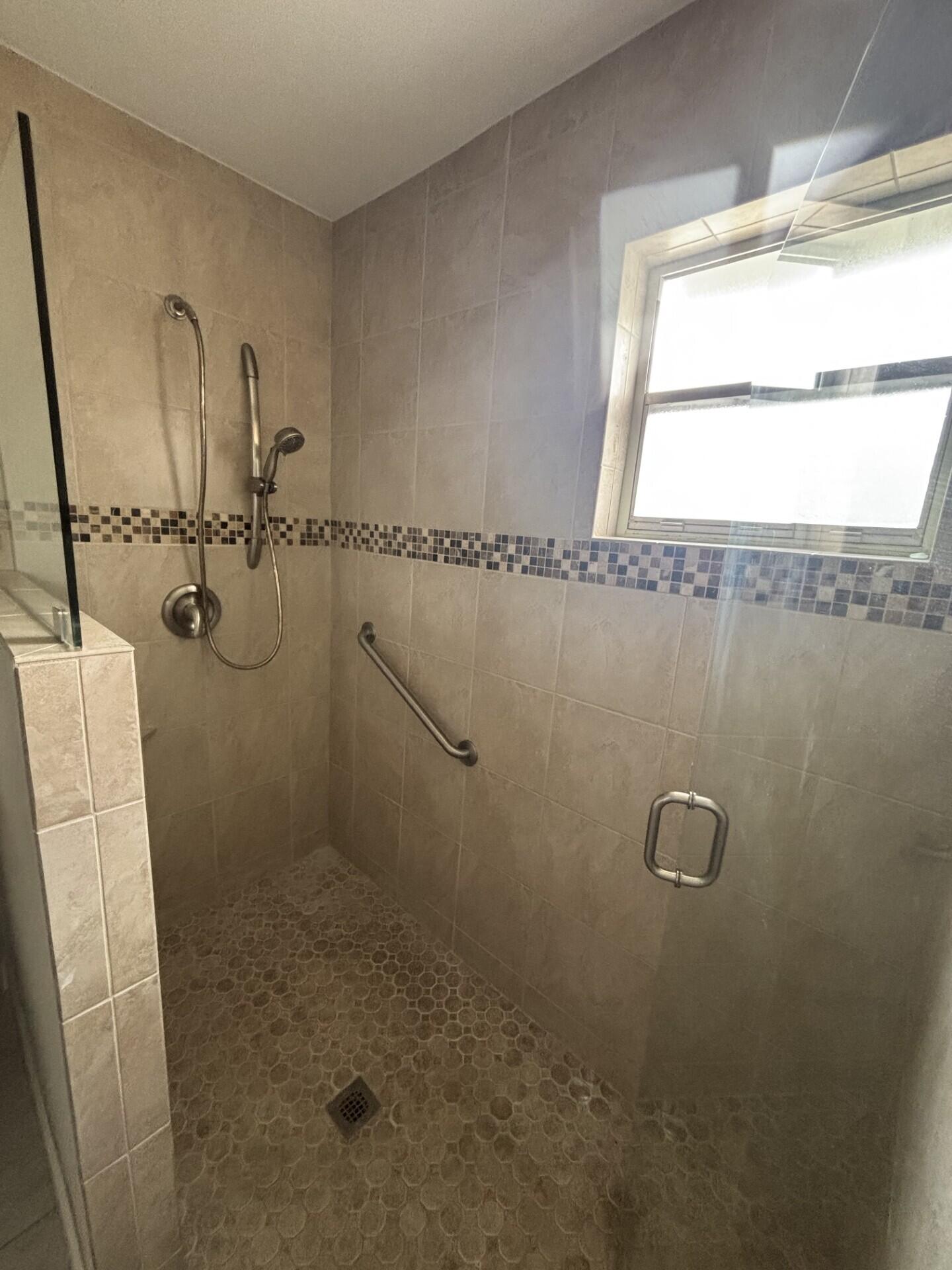 1160 East 12th Street Stuart, FL 34996 - Photo 19 of 25 a bathroom with a sink a toilet and a shower