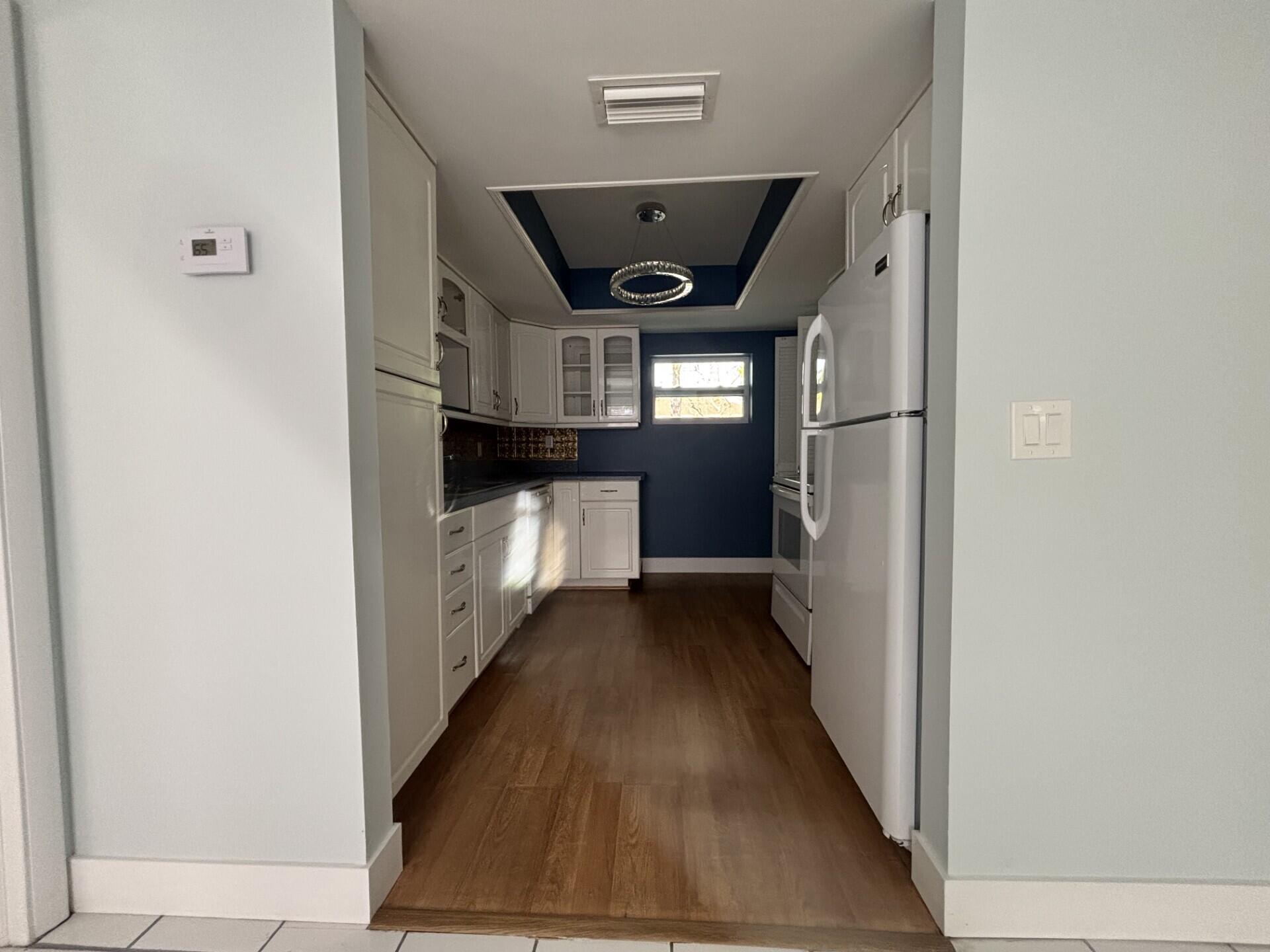 1160 East 12th Street Stuart, FL 34996 - Photo 6 of 25 a view of entryway and kitchen with a hallway