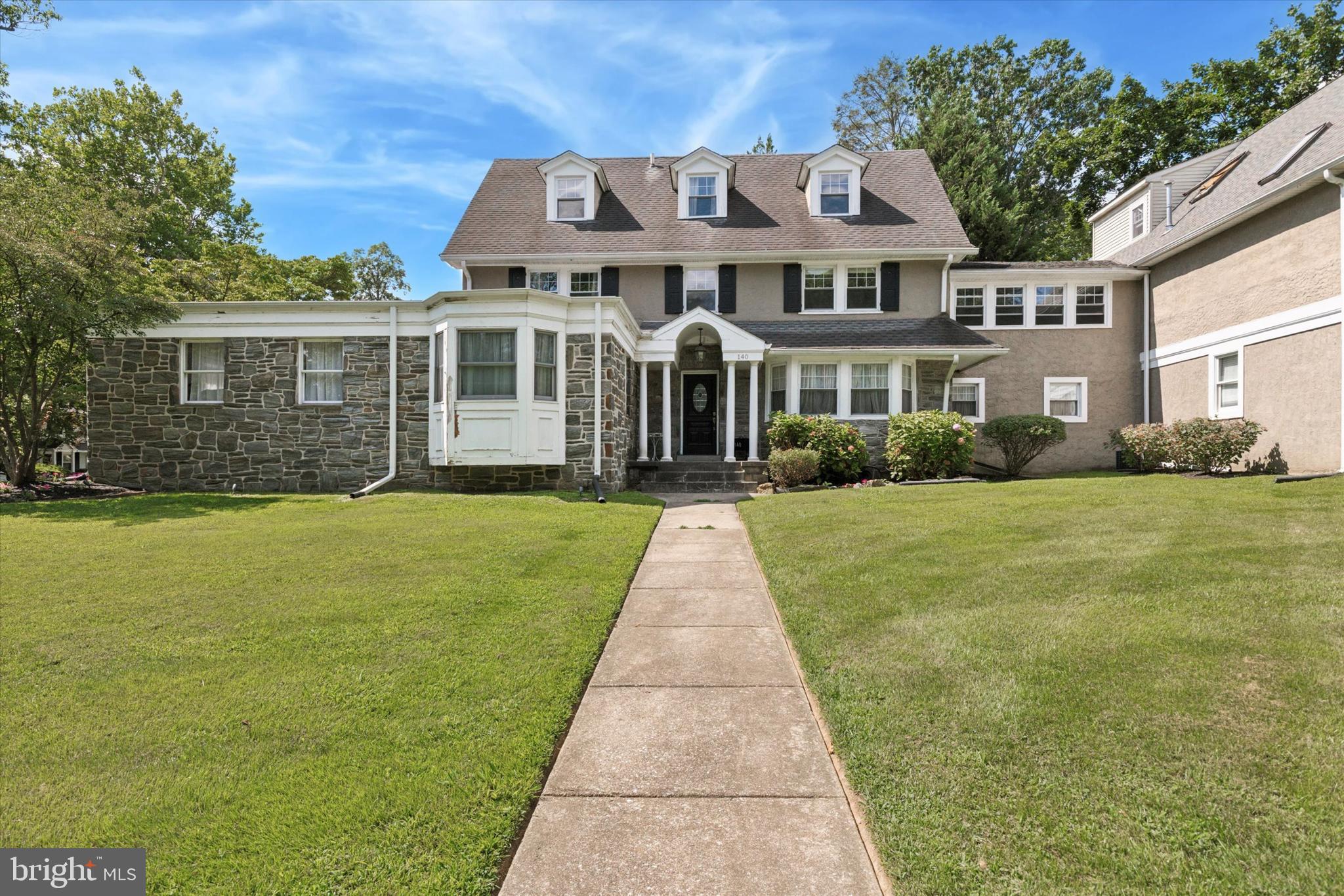 a front view of a house with a garden