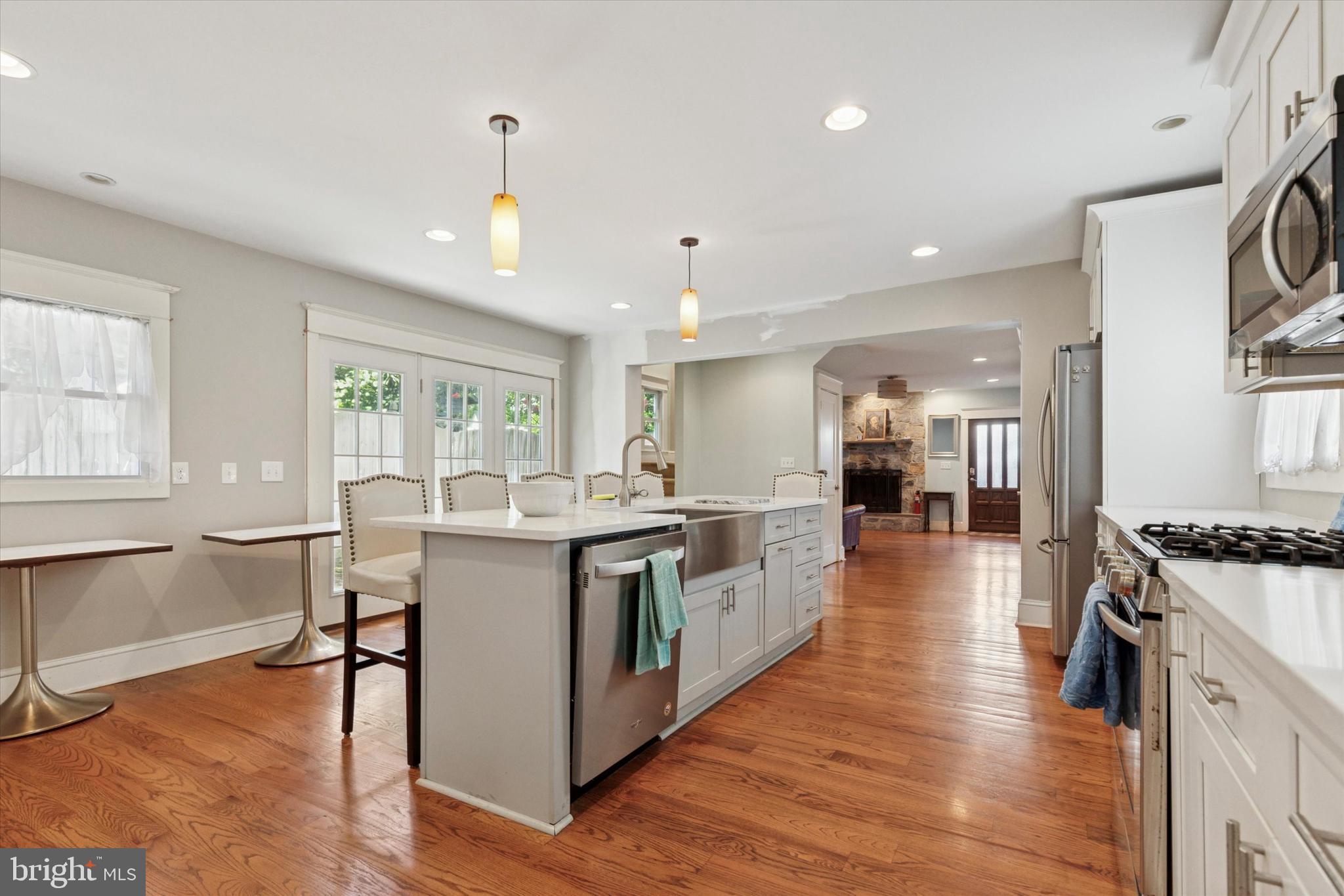 140 North Rolling Road Springfield, PA 19064 - Photo 14 of 34 a large white kitchen with lots of counter space a sink appliances and a large window