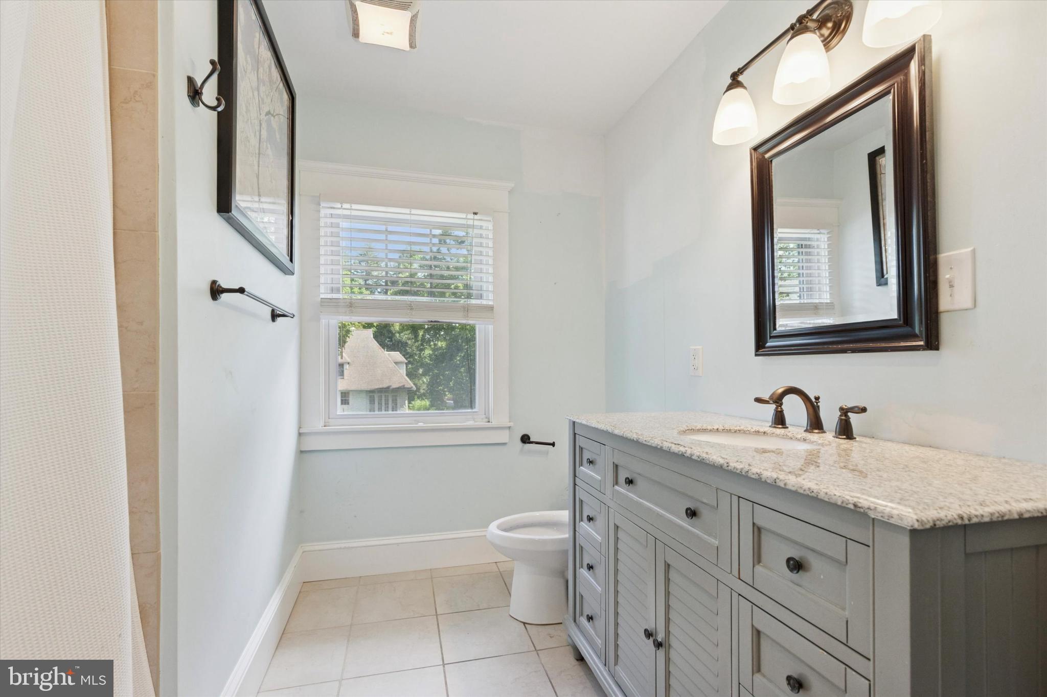 140 North Rolling Road Springfield, PA 19064 - Photo 24 of 34 a bathroom with a granite countertop sink a toilet and a mirror