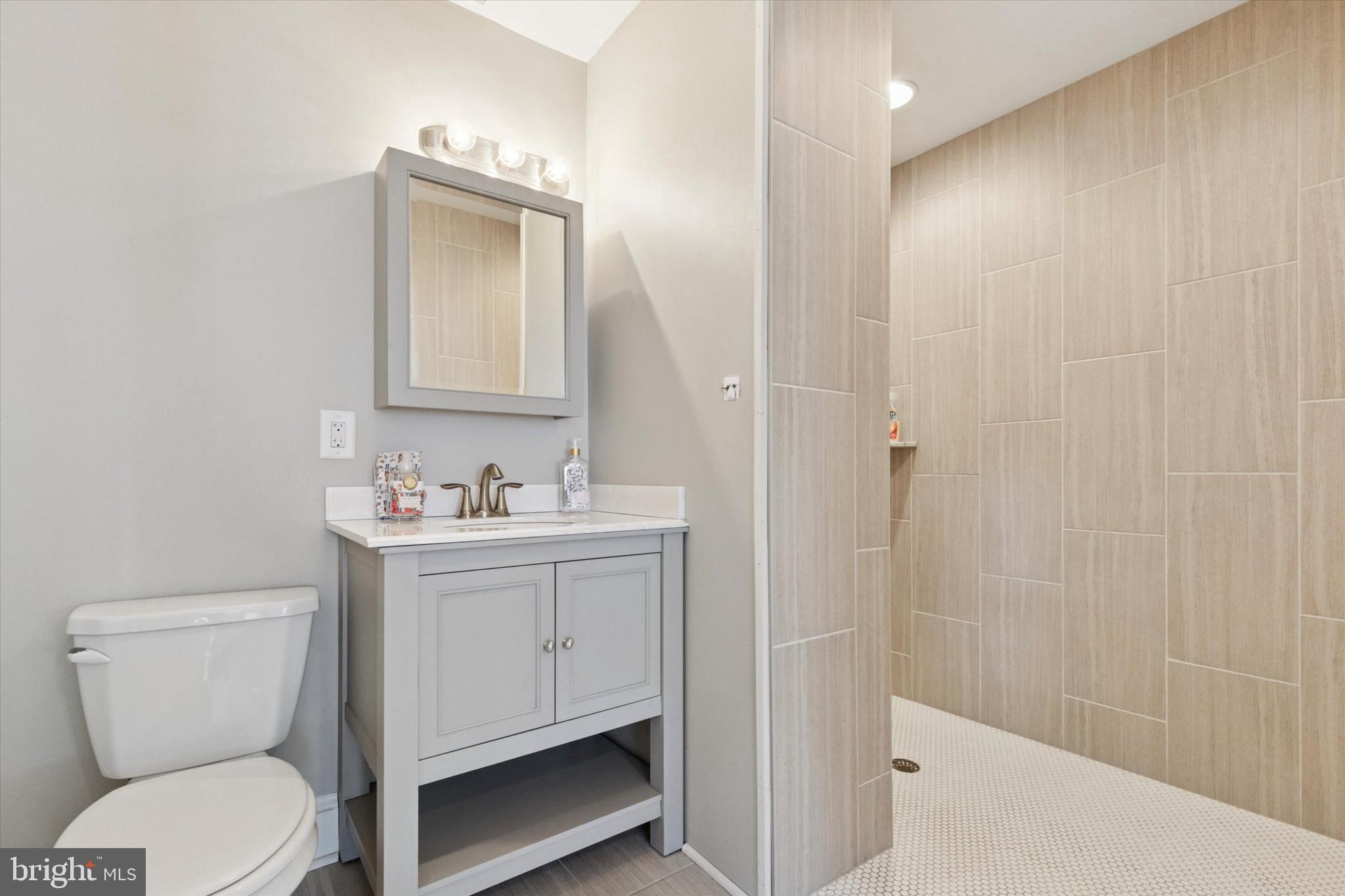 140 North Rolling Road Springfield, PA 19064 - Photo 27 of 34 a bathroom with a sink a toilet and shower