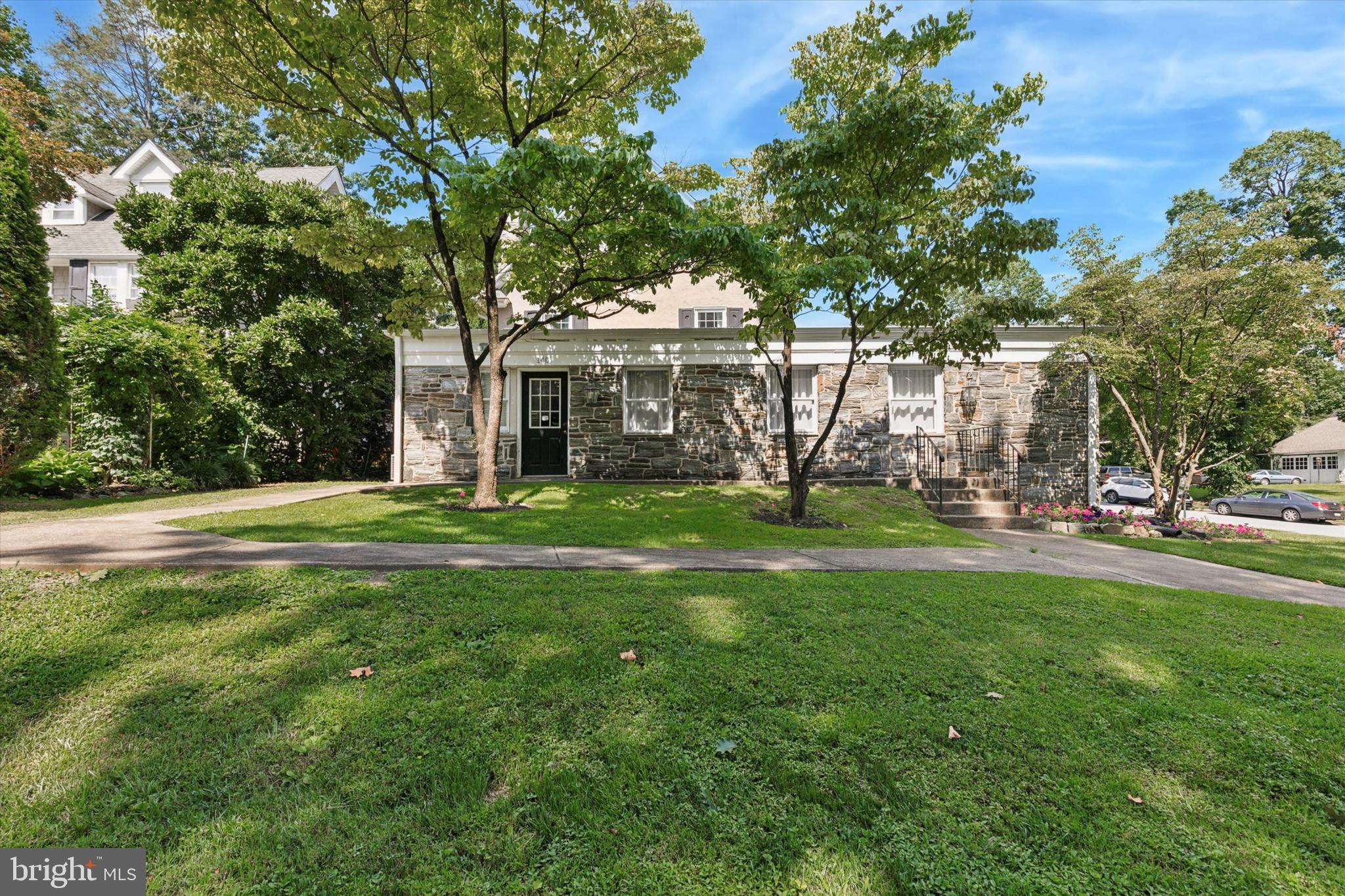 140 North Rolling Road Springfield, PA 19064 - Photo 3 of 34 a view of a house with a big yard and palm trees