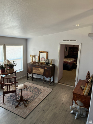 547 East 2000th Street North Vernal, UT 84078 - Photo 12 of 50 Spacious room featuring wood-finish flooring, light grey wall paint, and two large windows with blinds