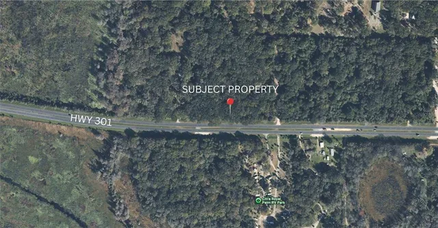 a view of a water fountain with large trees