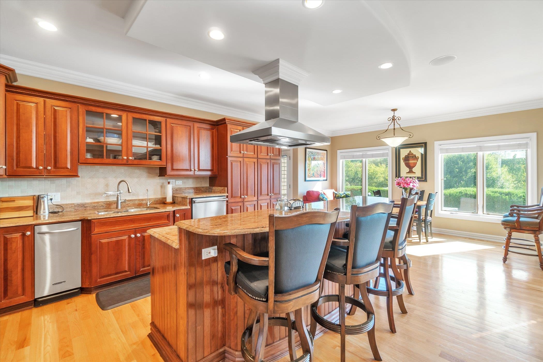12535 Bellingham Road Caledonia, IL 61011 - Photo 11 of 57 a dining area with stainless steel appliances granite countertop a stove top oven a dining table and chairs with wooden floor
