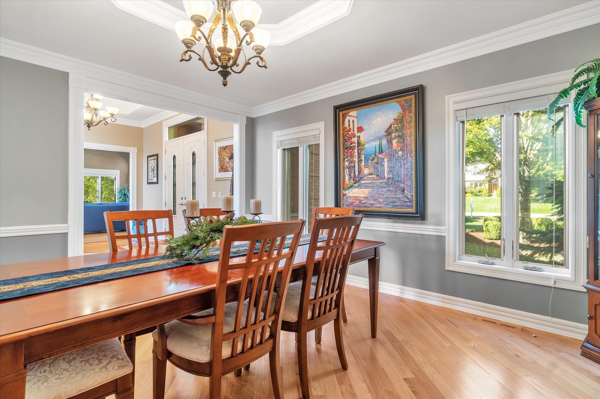 12535 Bellingham Road Caledonia, IL 61011 - Photo 18 of 57 a view of a dining room with furniture large windows and wooden floor
