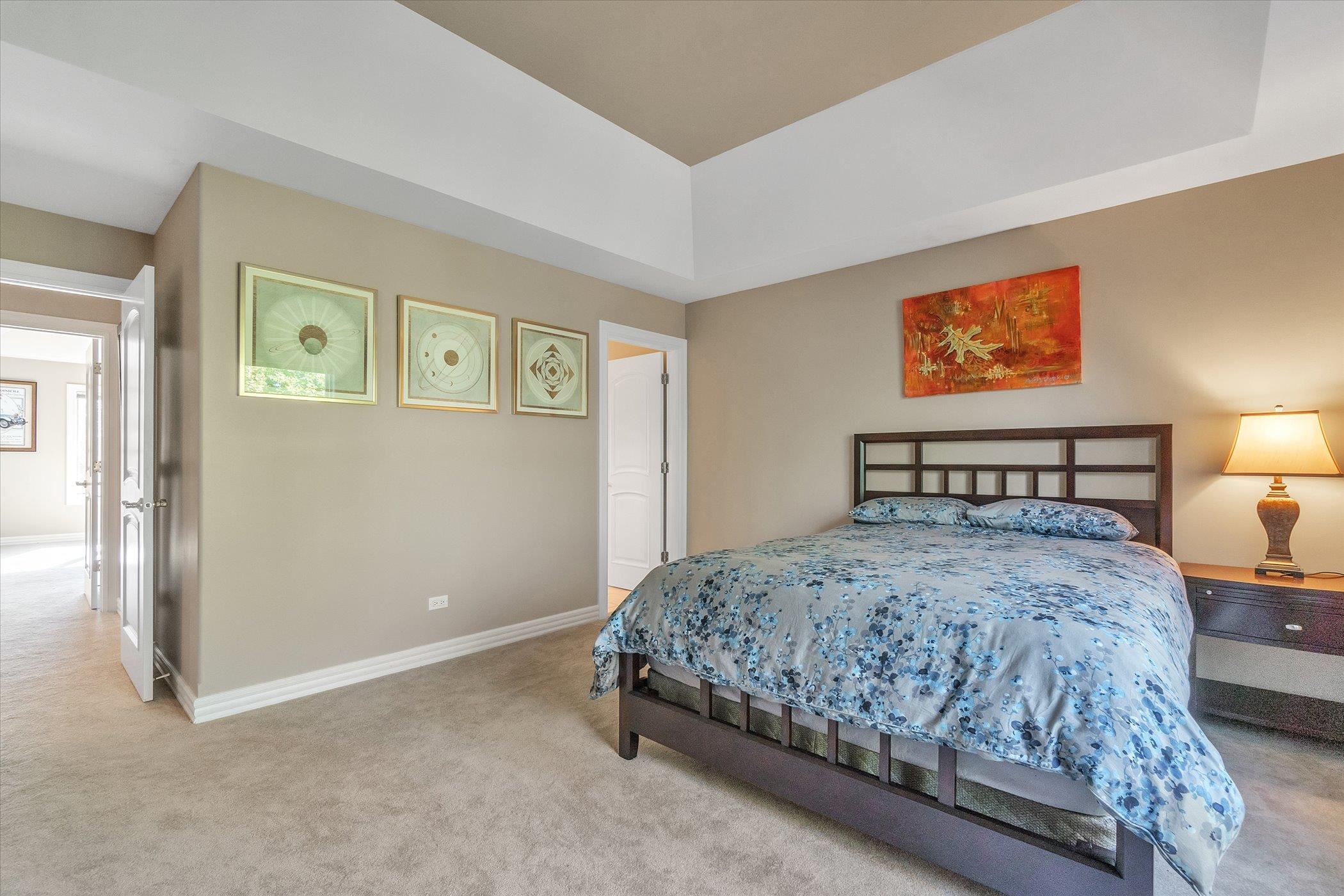 12535 Bellingham Road Caledonia, IL 61011 - Photo 39 of 57 a bedroom with a bed and a lamp on dresser