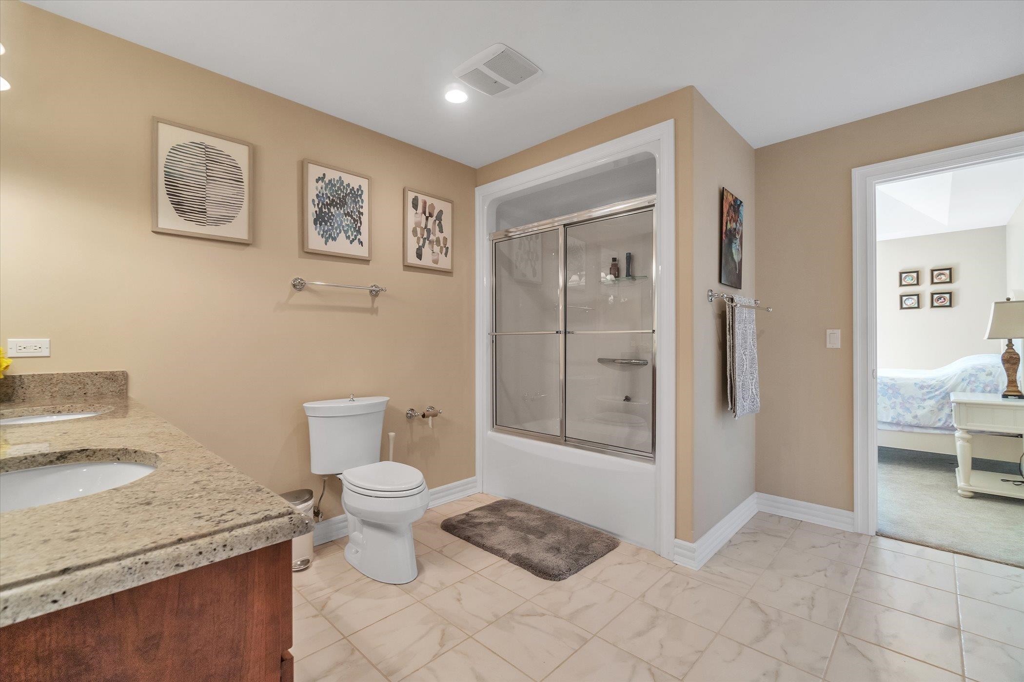 12535 Bellingham Road Caledonia, IL 61011 - Photo 42 of 57 a bathroom with a granite countertop toilet and a shower