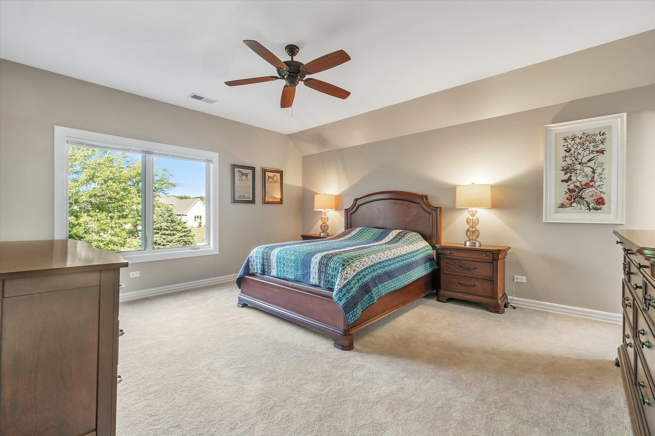 12535 Bellingham Road Caledonia, IL 61011 - Photo 43 of 57 a bedroom with a bed next to a window and a chandelier